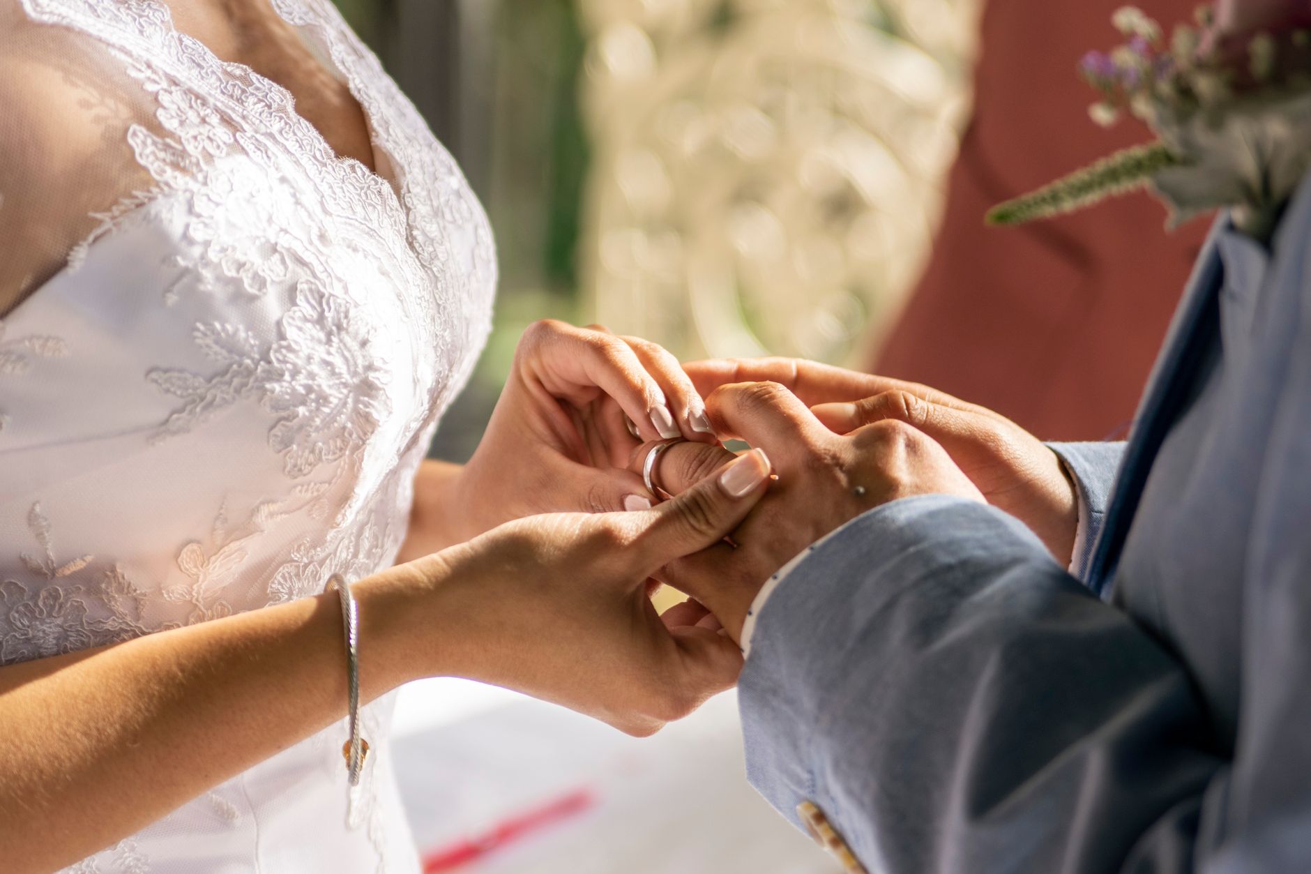 Close-up of a couple exchanging rings, capturing the intimacy and emotion of a wedding ceremony. — Something Old Is Totally N