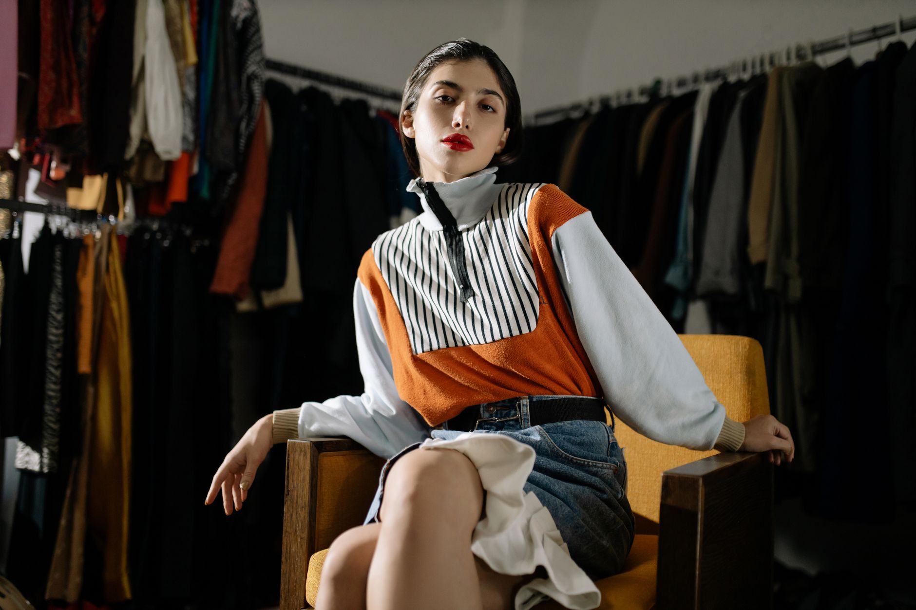 Confident woman in a stylish retro outfit posing on a chair. Vintage fashion in a modern setting. — The 2 Best New Designer C