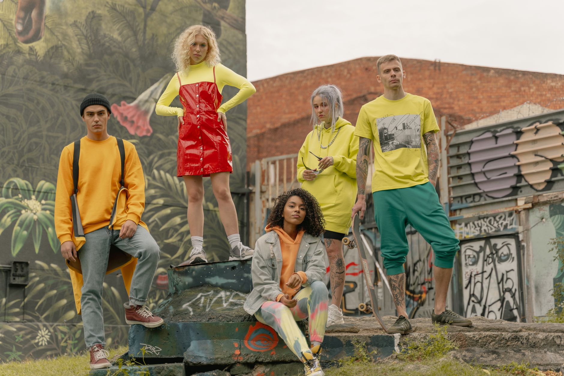 Fashionable group posing in vibrant street style against graffiti mural backdrop. — The Right Terms for Choosing the Right Bl