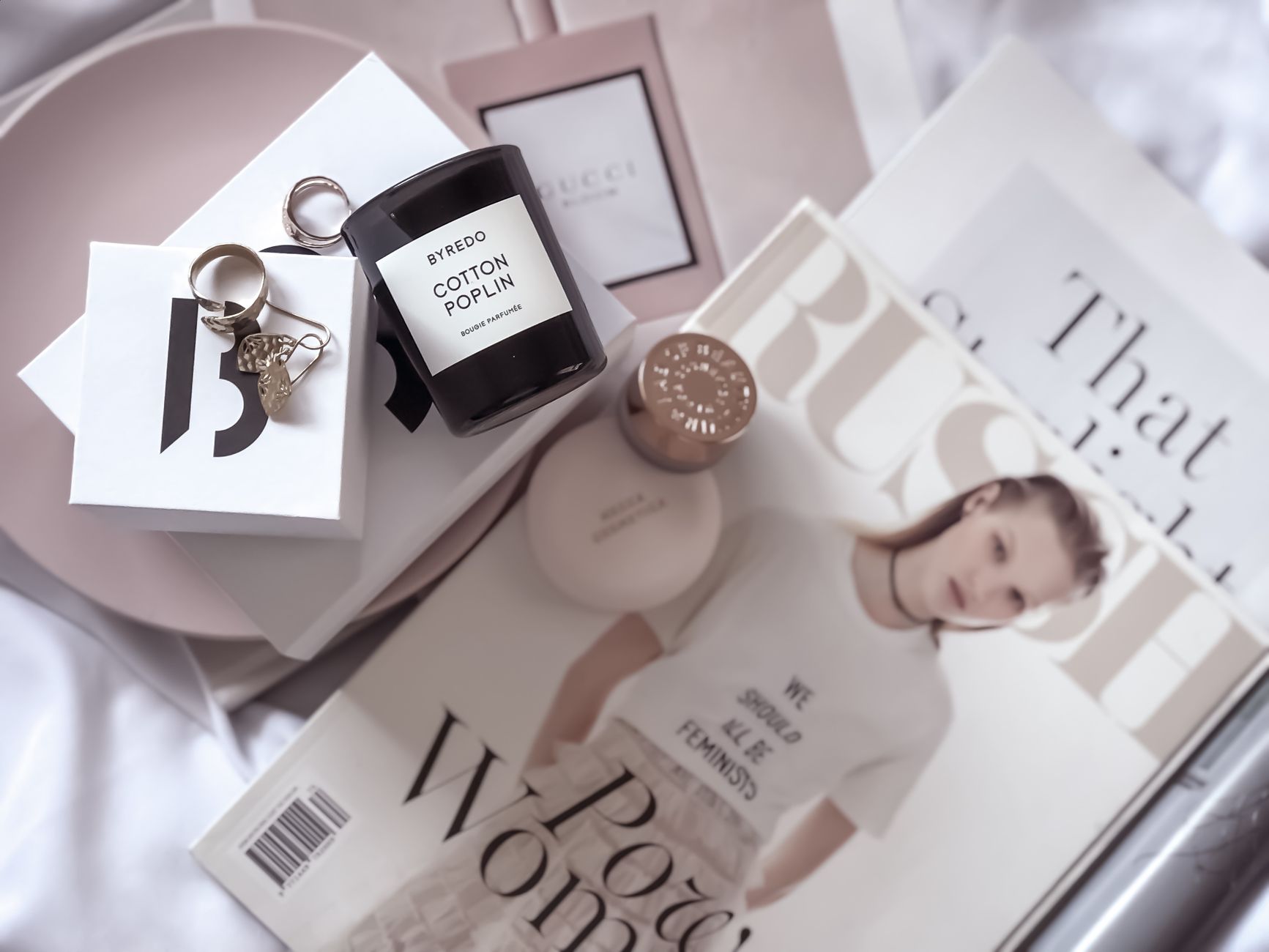 Stylish flat lay featuring fashion magazines, Byredo candle, and accessories. — V-Shape Botox Gives Your Face A More Defined